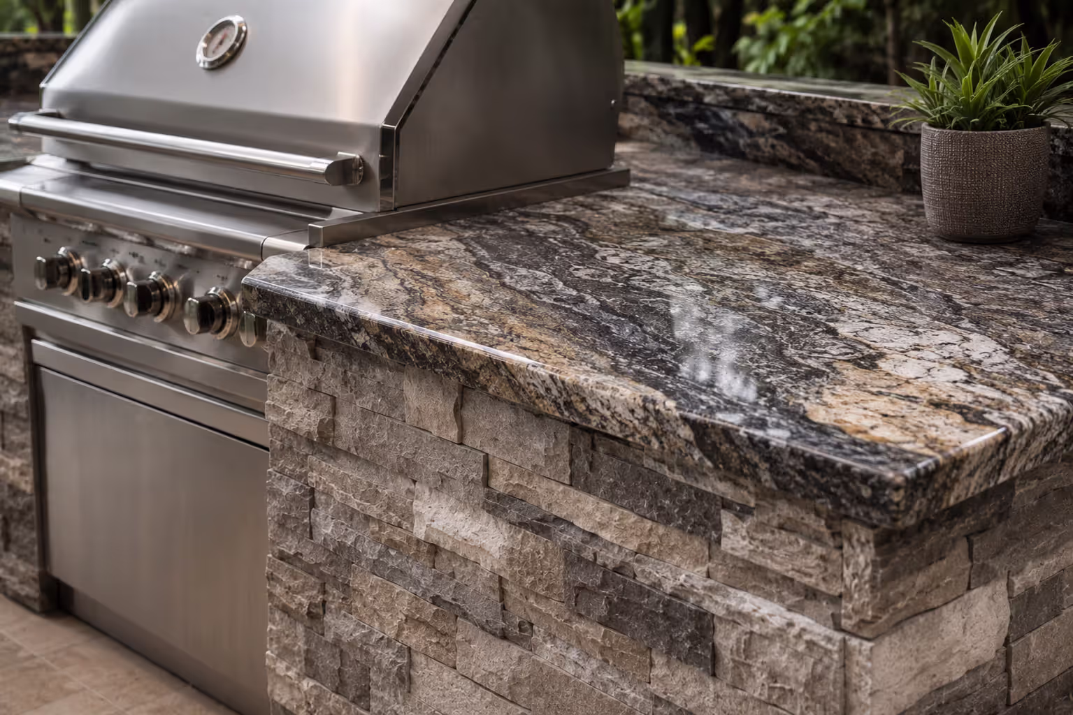 granite countertop and stacked stone outdoor kitchen island
