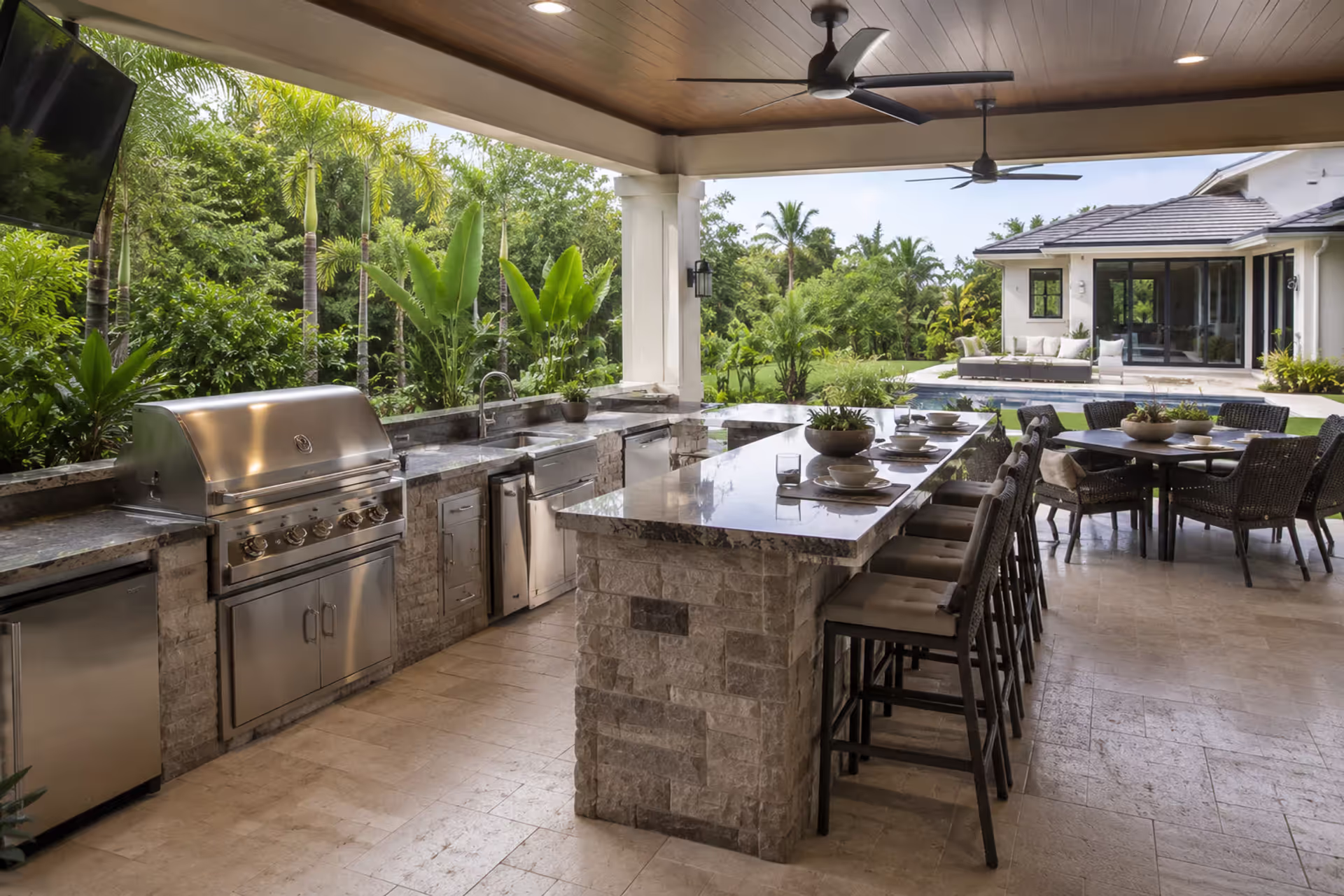 covered lanai outdoor kitchen with built in grill and seating area