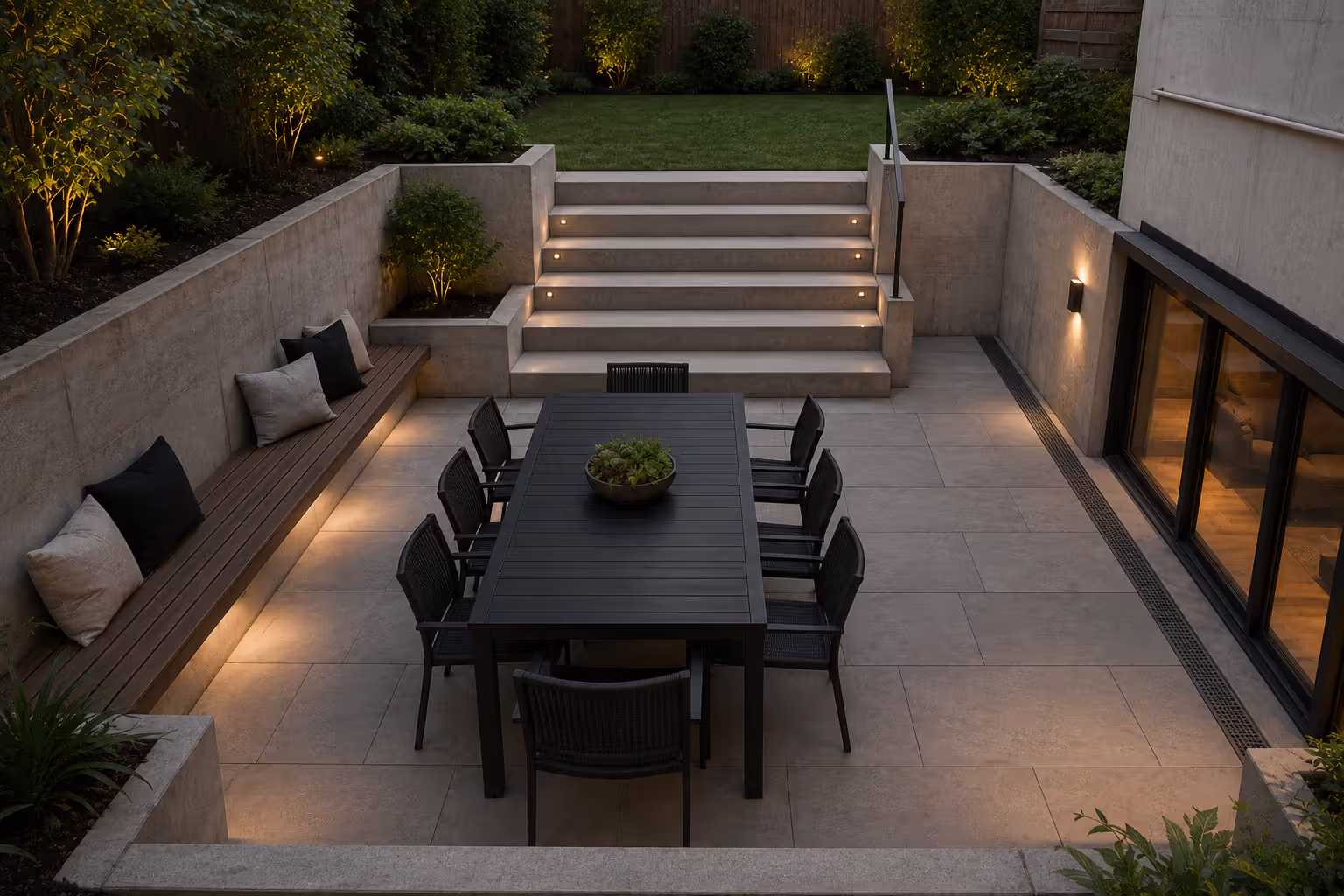 sunken paver patio with retaining walls and outdoor dining area